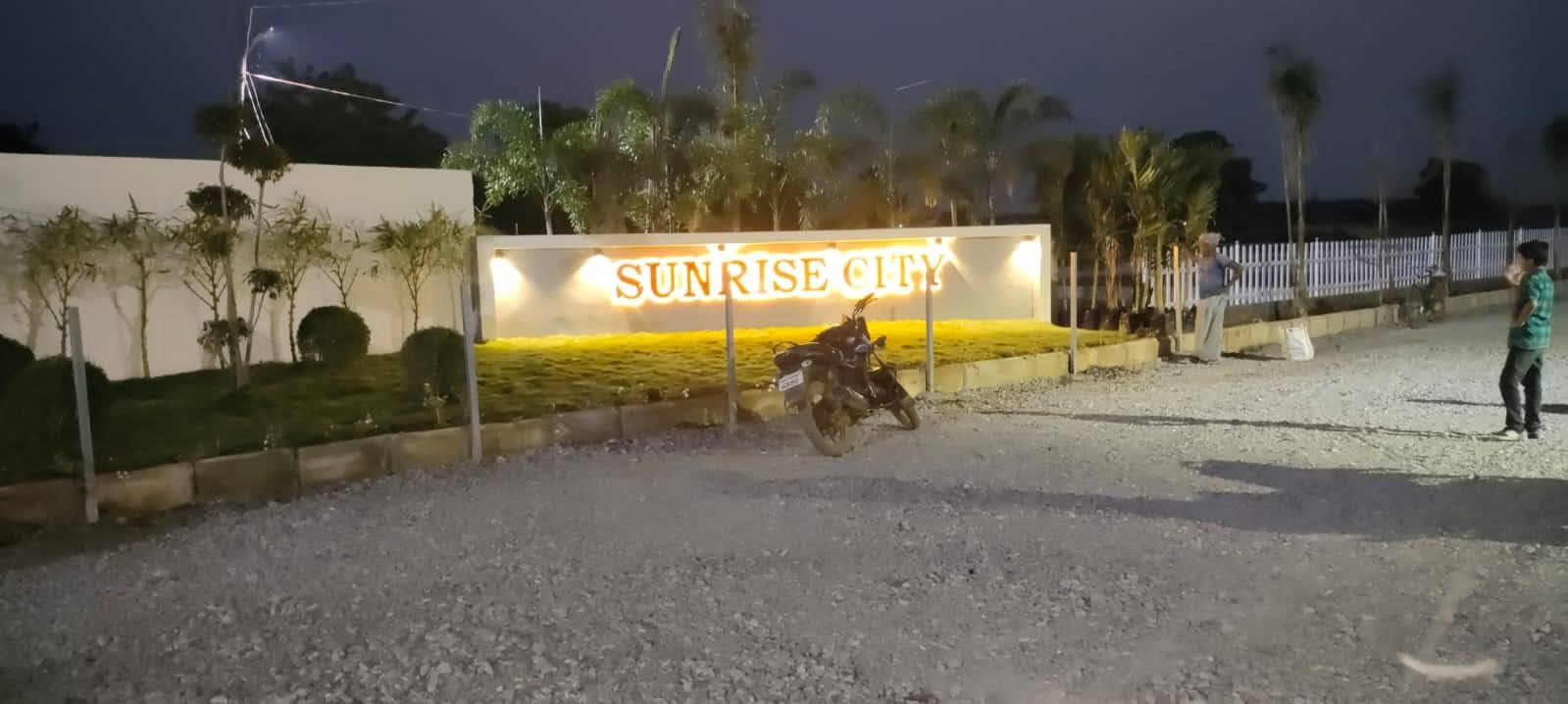 Sunrise City layout entrance with landscaping at night