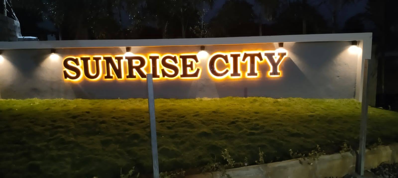 Sunrise City illuminated entrance sign at night